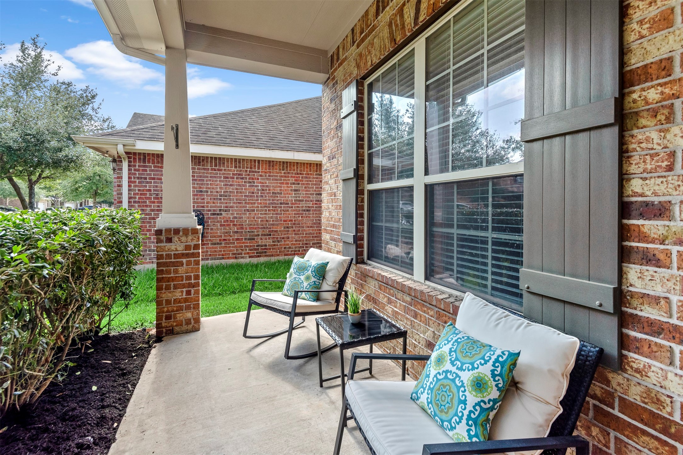 6211 Flagg Ranch Drive Spring, TX 77388 - Photo 5 of 36 Enjoy a cozy covered front porch, perfect for relaxing with morning coffee or evening conversations. Thoughtfully designed seating area adds to the home’s inviting curb appeal.