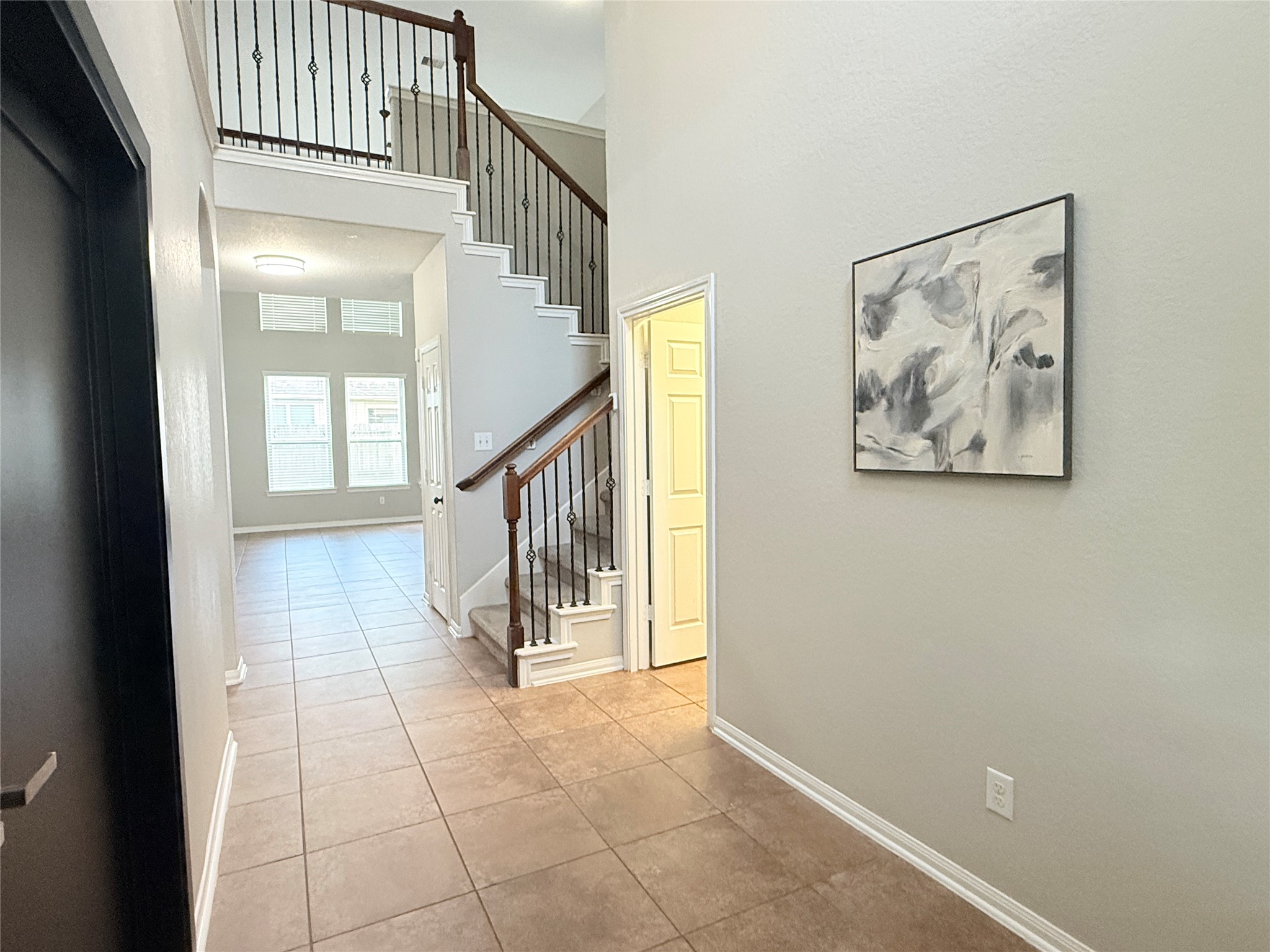 6211 Flagg Ranch Drive Spring, TX 77388 - Photo 7 of 36 Just off the foyer, French doors on the left open to a flex space or office/study space, while a conveniently located utility room on the right provides direct garage access.