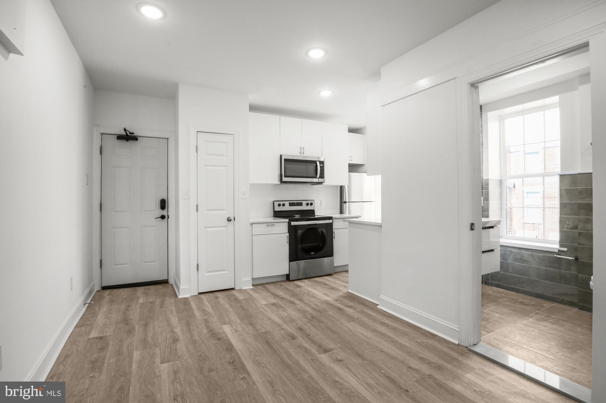 2046 East Huntingdon Street, Unit 2F Philadelphia, PA 19125 - Photo 6 of 15 a kitchen with a refrigerator and a stove top oven