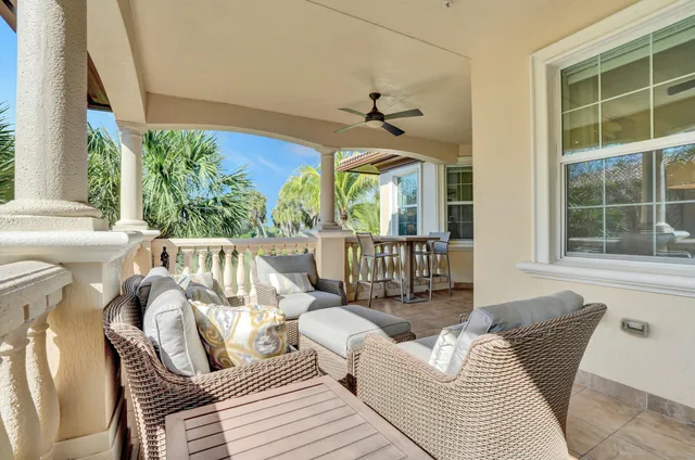 a balcony with furniture and a potted plant