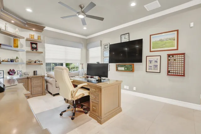 a view of a workspace with furniture and a flat screen tv