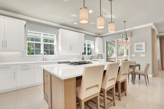 a kitchen with a stove a table and chairs in it
