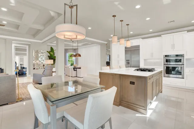 a kitchen with kitchen island granite countertop a sink a center island and cabinets