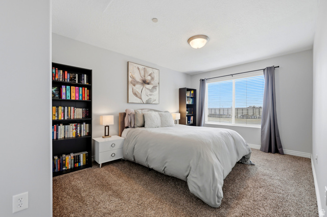 116 East Resaca Drive, Unit F6 Sandy, UT 84070 - Photo 18 of 32 Carpeted room featuring a large window with horizontal blinds, light gray wall paint, a flush-mount ceiling light fixture, and white baseboards