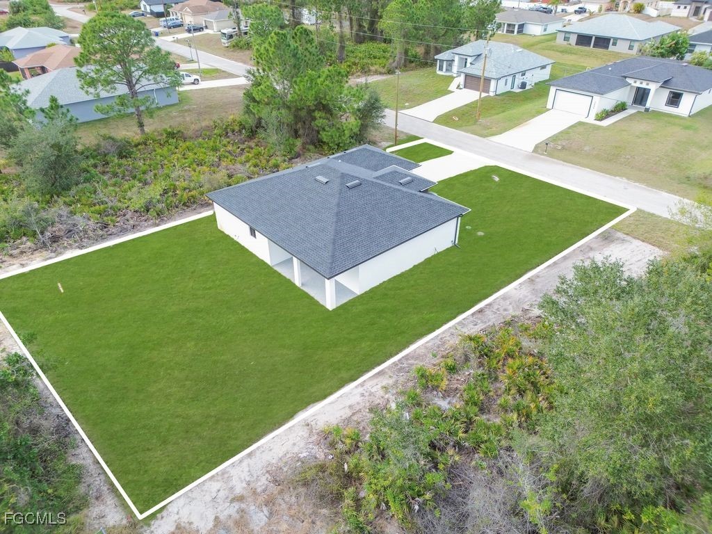 2605 26th Street Southwest Lehigh Acres, FL 33976 - Photo 3 of 20 a view of an house with backyard and pool