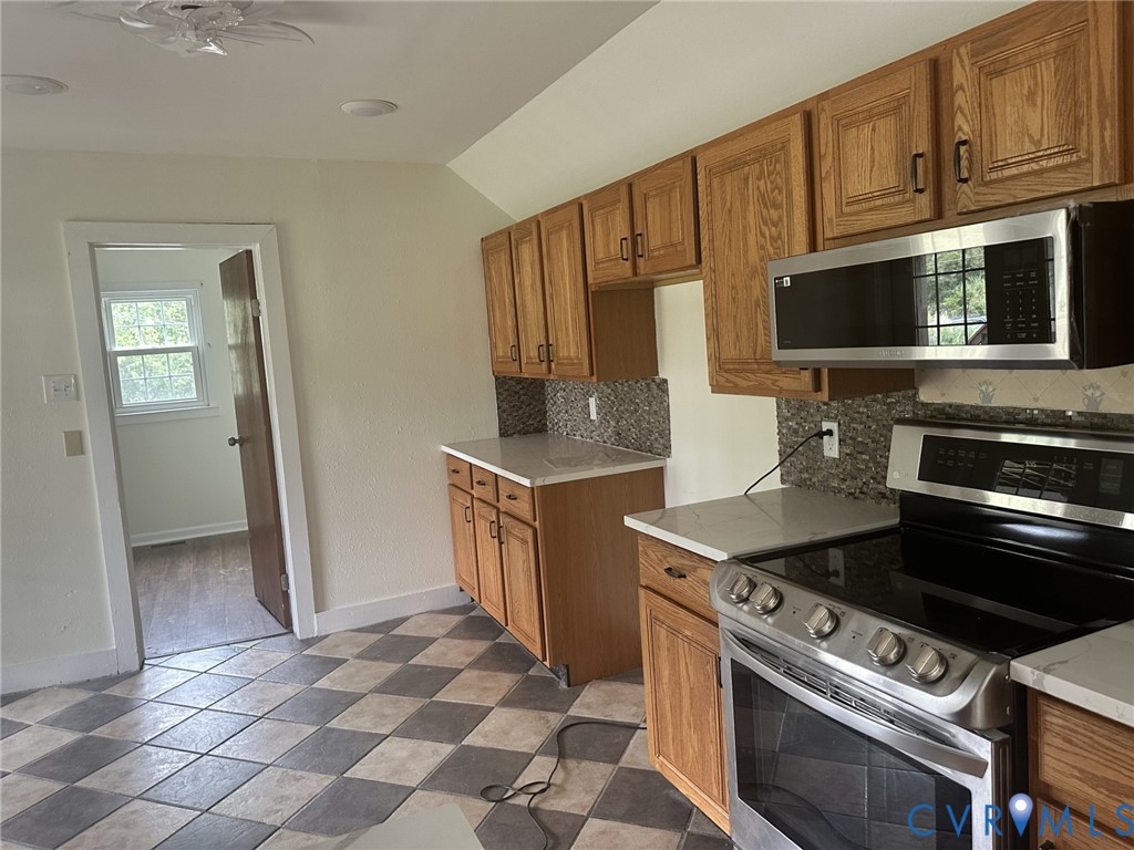 803 Beach Road Hampton, VA 23664 - Photo 16 of 43 a kitchen with stainless steel appliances a stove a microwave and a sink