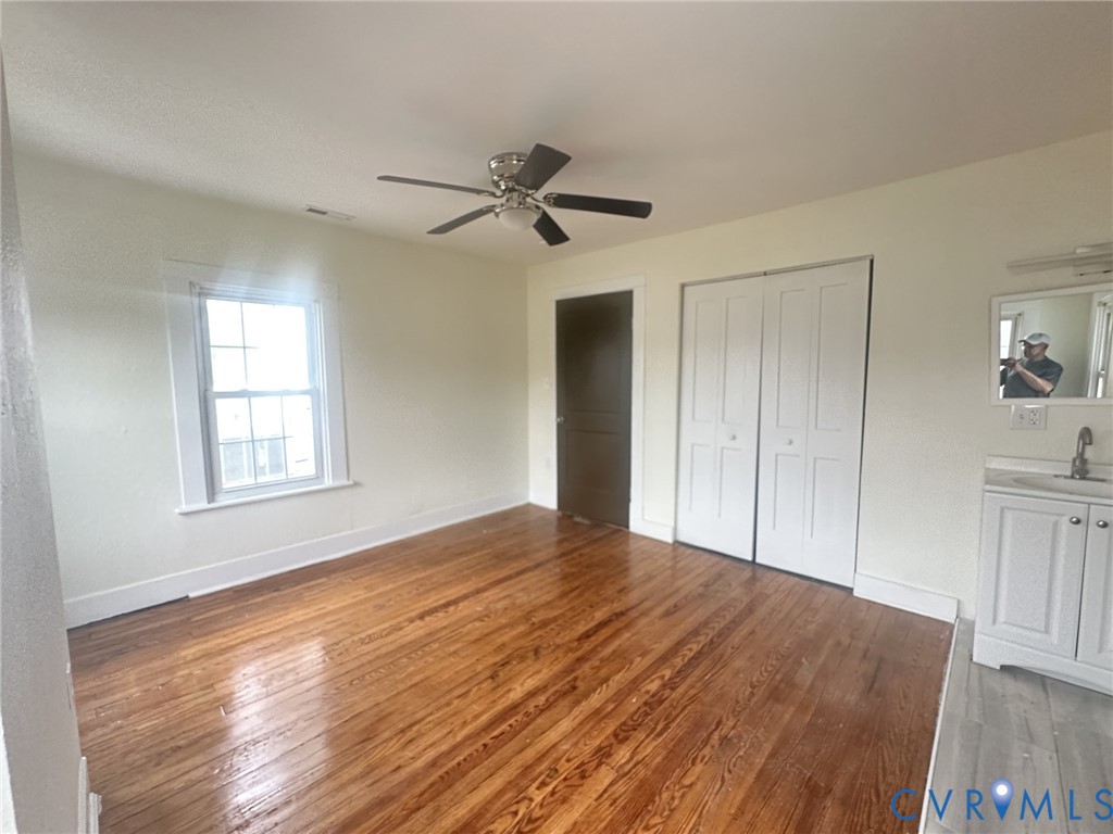 803 Beach Road Hampton, VA 23664 - Photo 21 of 43 a view of an empty room with window and wooden floor