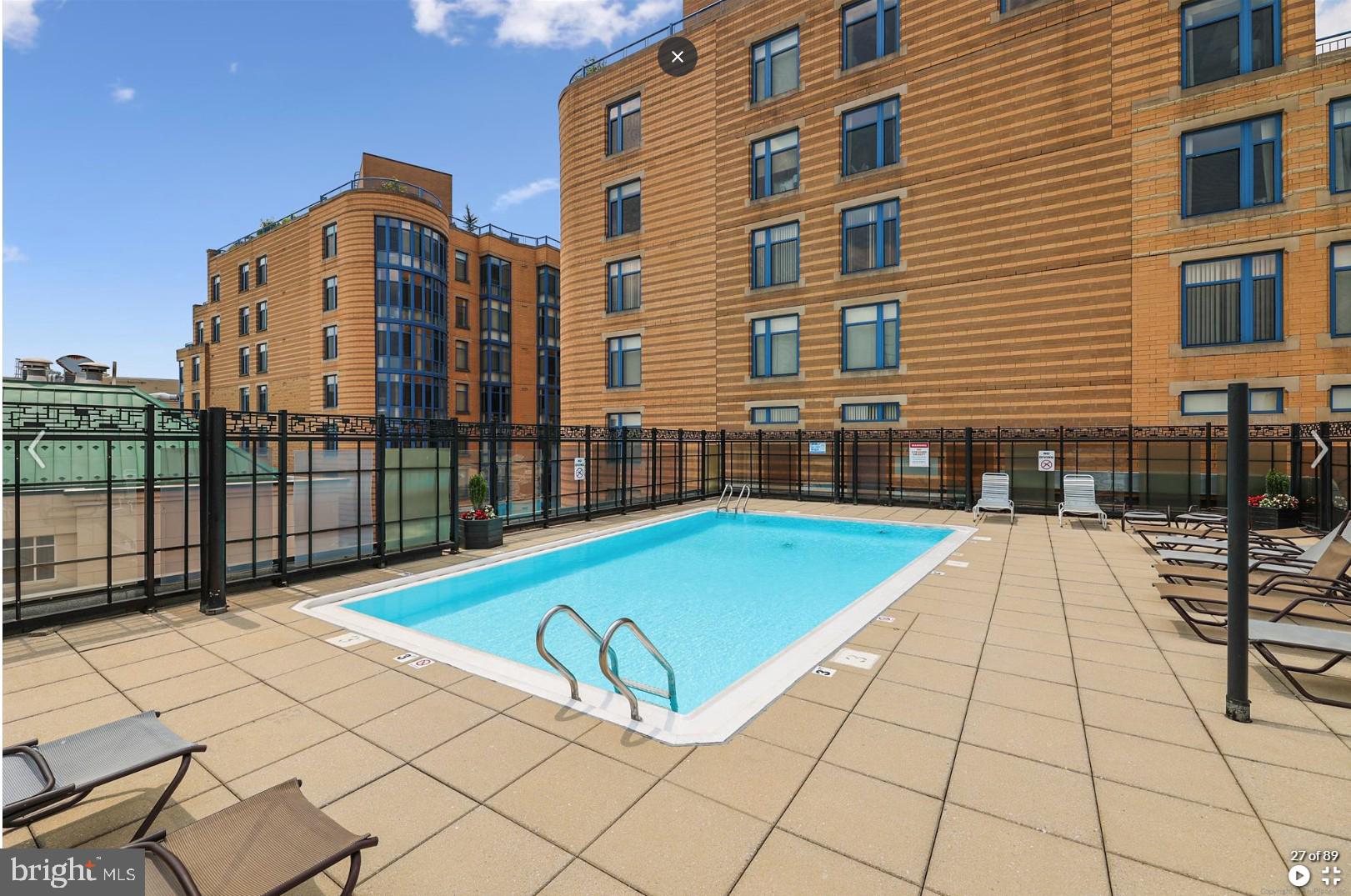 1440 Northwest N Street Northwest, Unit 404 Washington, DC 20005 - Photo 1 of 24 a view of a swimming pool with a lounge chairs
