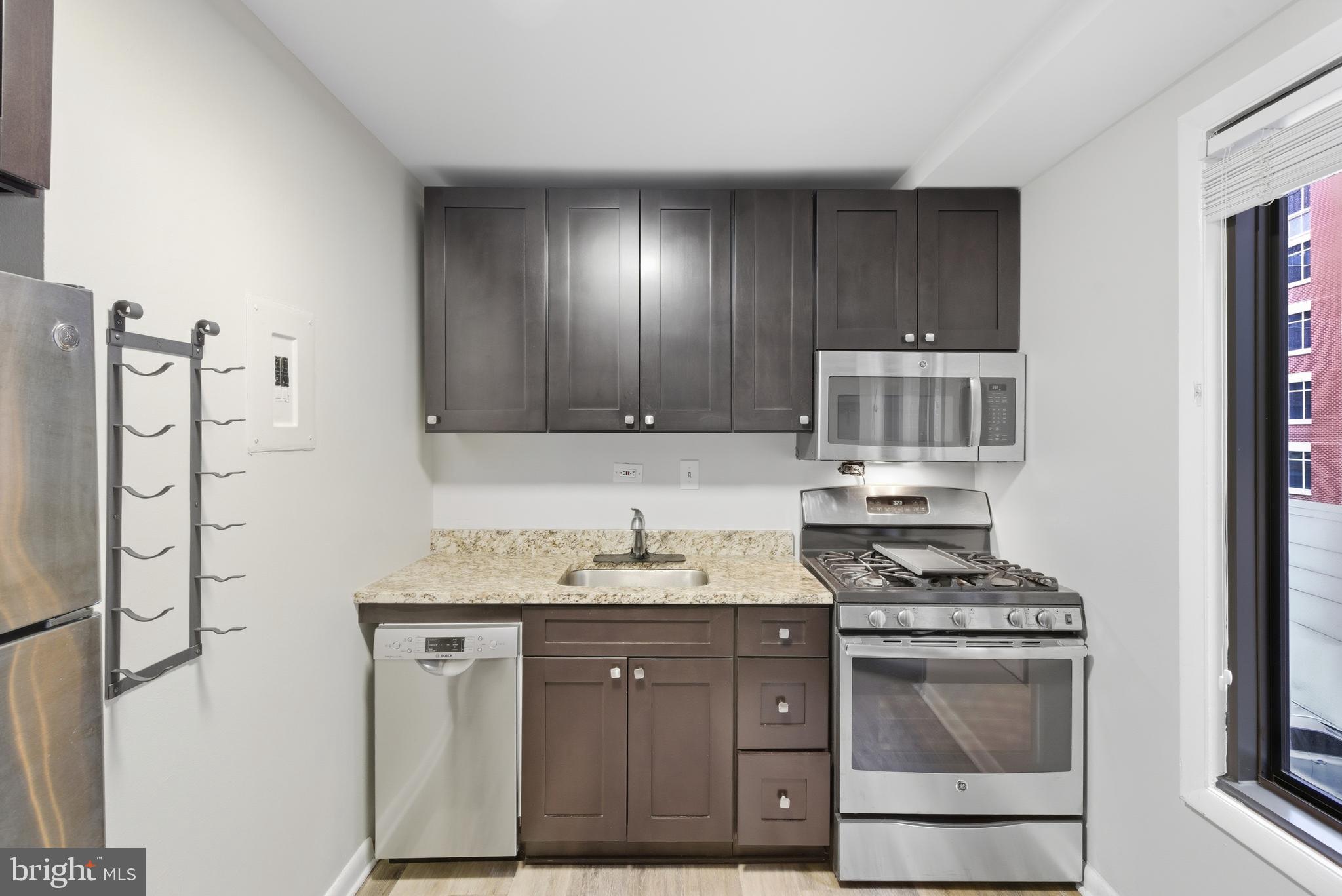 1440 Northwest N Street Northwest, Unit 404 Washington, DC 20005 - Photo 14 of 24 a kitchen with stainless steel appliances a stove and a refrigerator