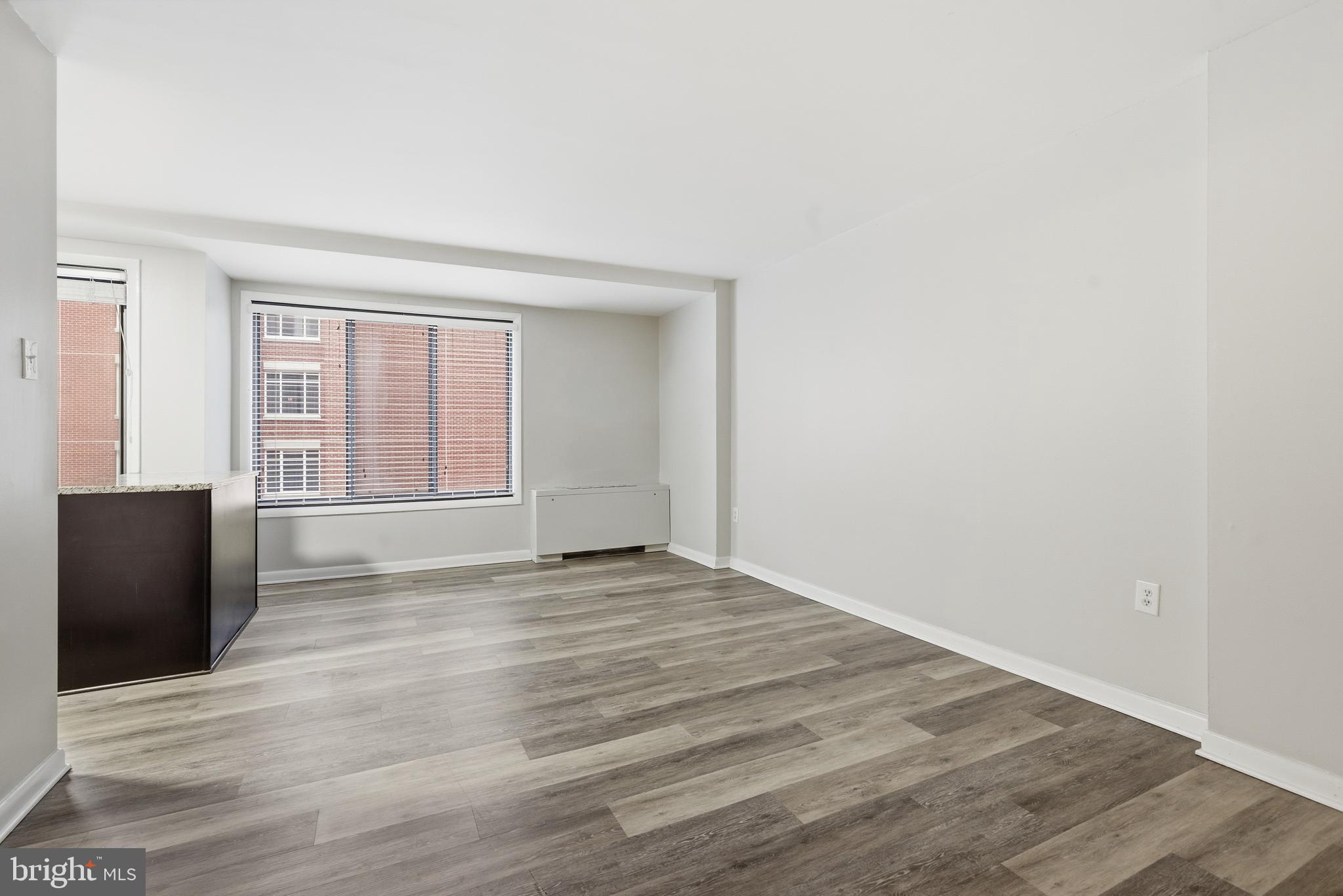 1440 Northwest N Street Northwest, Unit 404 Washington, DC 20005 - Photo 19 of 24 an empty room with wooden floor and windows