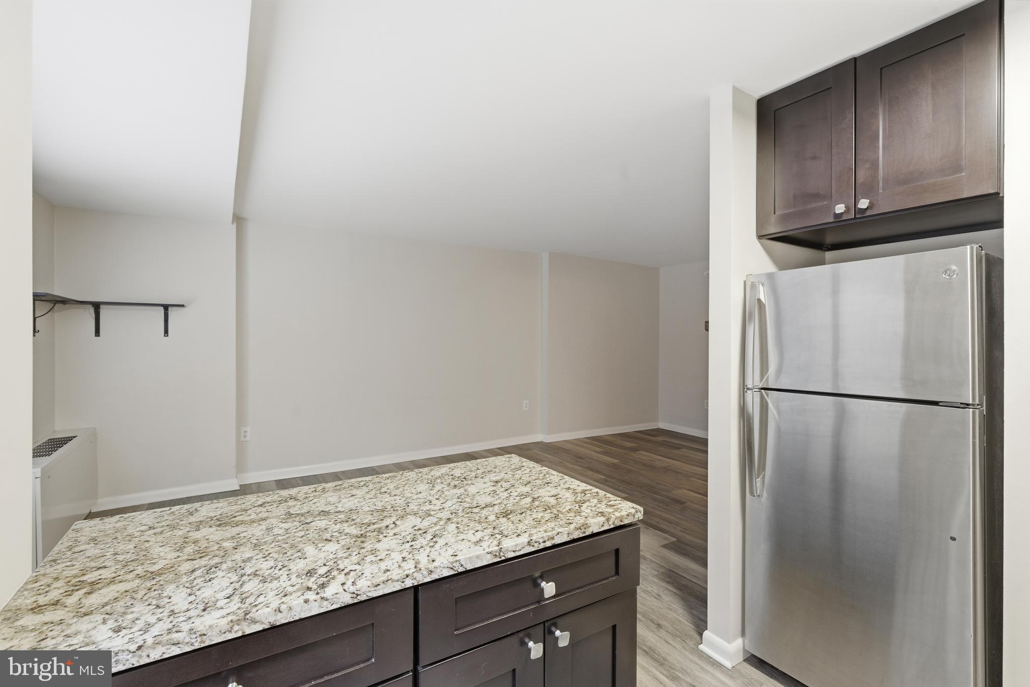 1440 Northwest N Street Northwest, Unit 404 Washington, DC 20005 - Photo 10 of 24 a kitchen with a refrigerator and cabinets