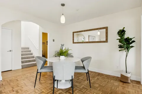 a view of a livingroom with furniture and a potted plant