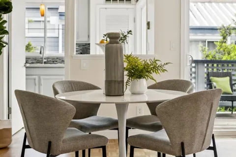 a dining room with furniture and wooden floor