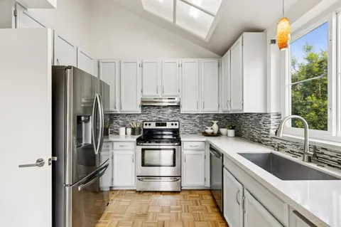 a kitchen with a sink appliances and cabinets