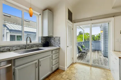 a kitchen with a sink and a large window