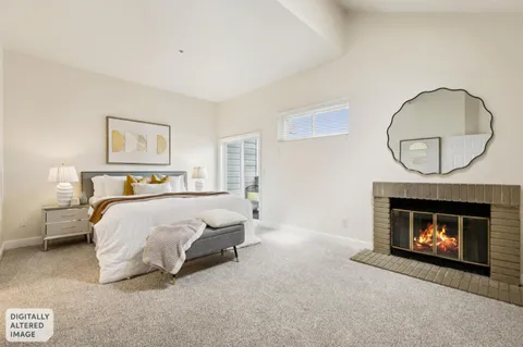 a bedroom with a bed and painting on the wall