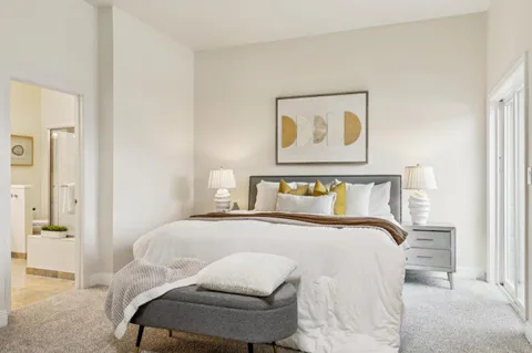 a bedroom with a bed and chair