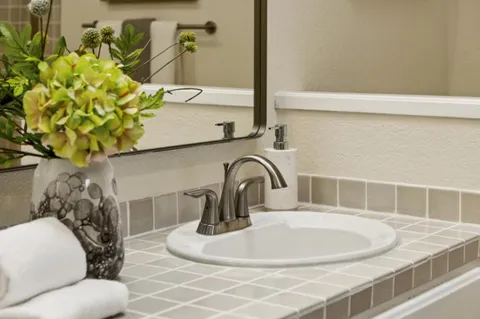 a bathroom with double vanity sinks and a mirror