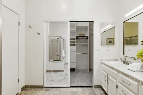 a view of walk in closet with empty racks
