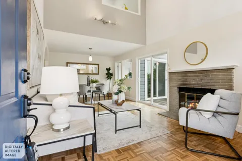 a living room with furniture a fireplace and a window
