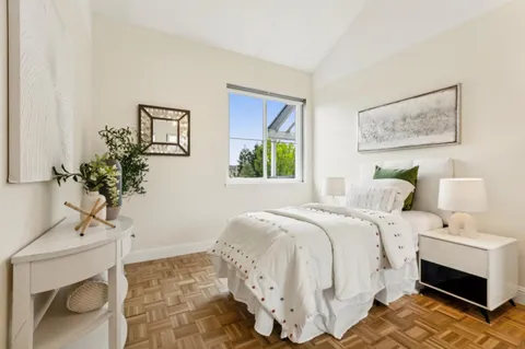 a bedroom with a bed and a large mirror