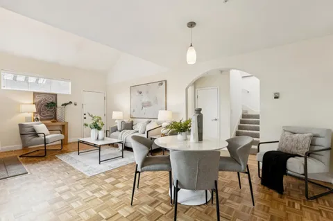 a living room with furniture and wooden floor