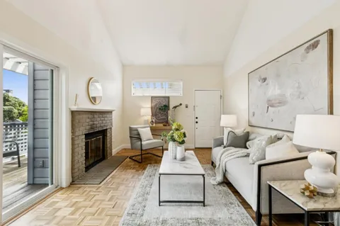 a living room with furniture a fireplace and a large mirror