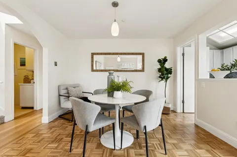 a view of a dining room with furniture and wooden floor