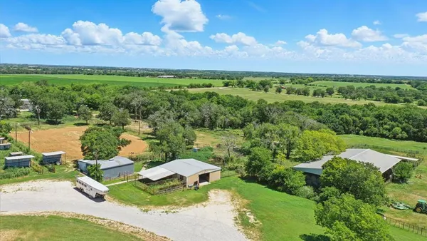 an aerial view of a house with garden space and outdoor seating