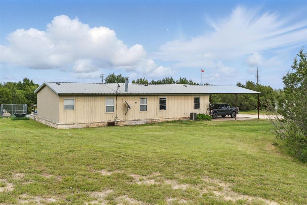 392 Tbd County Road Stephenville, TX 76401 - Photo 18 of 18 a front view of a house with a garden