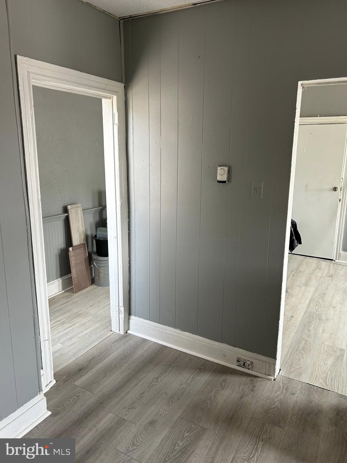 an empty room and a bathroom with a sink