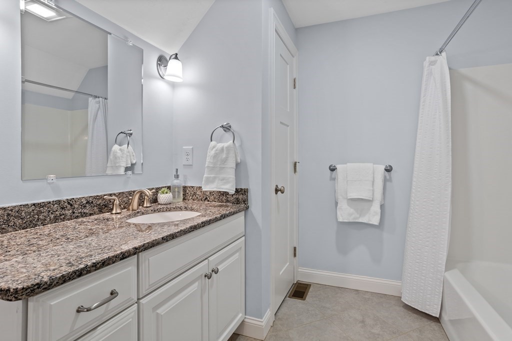 32 Harvard Road Bolton, MA 01740 - Photo 31 of 35 a bathroom with a granite countertop sink and a mirror