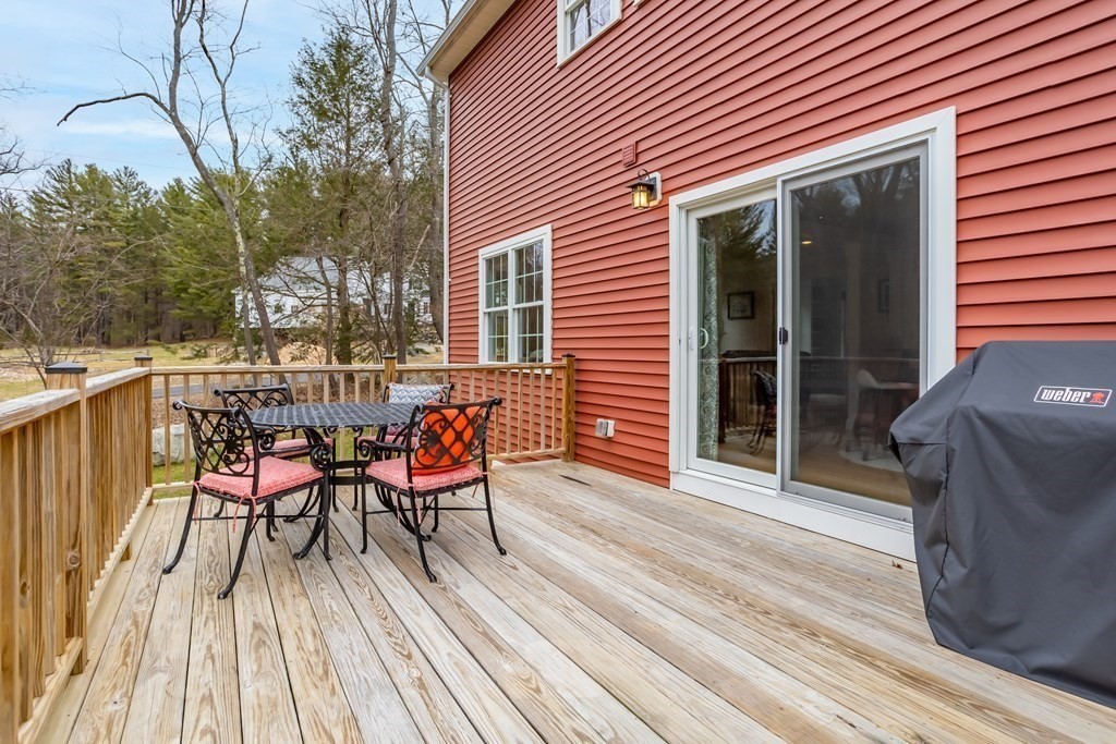 32 Harvard Road Bolton, MA 01740 - Photo 34 of 35 a balcony with wooden floor table and chairs