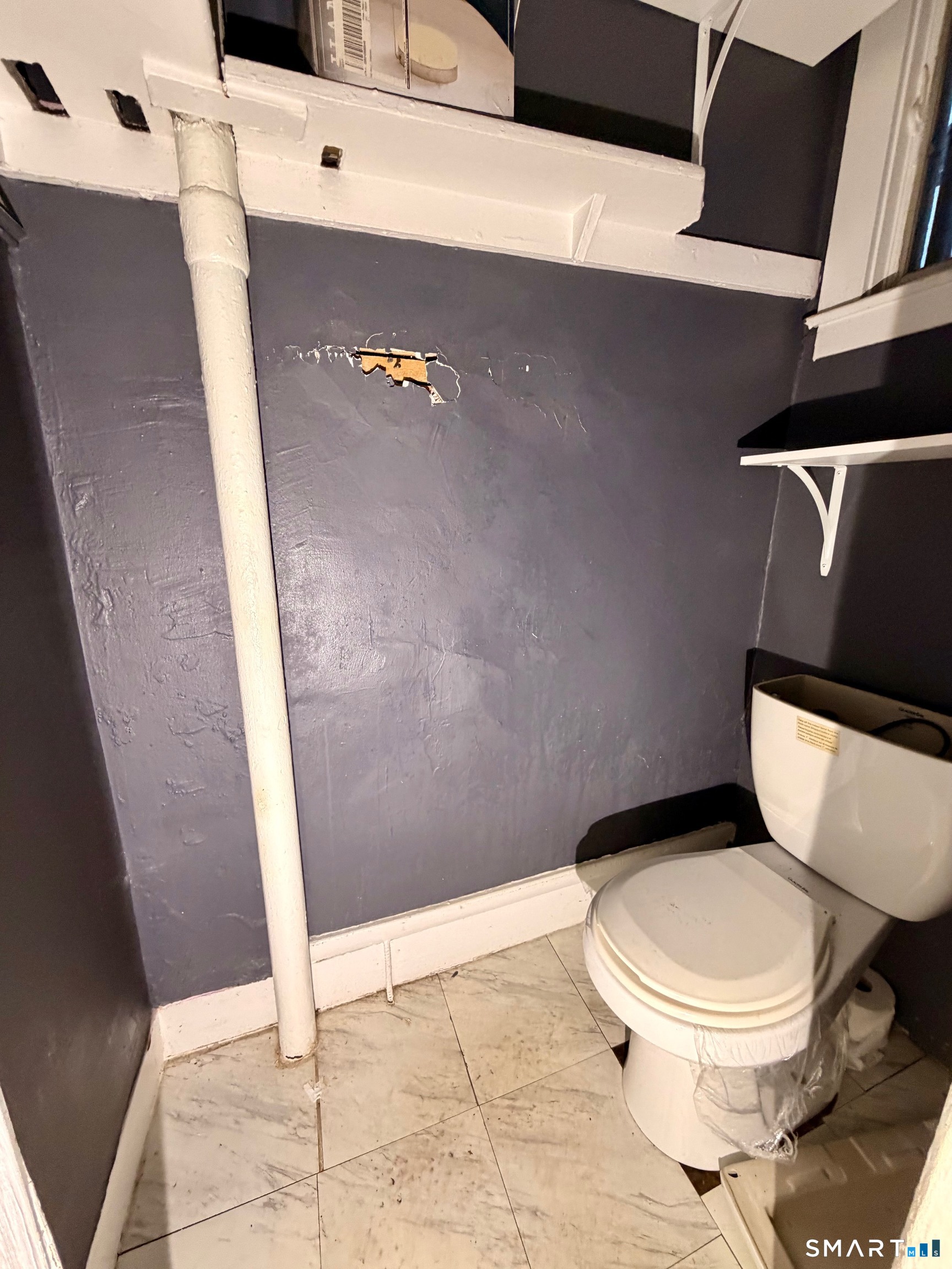 86 Linsley Avenue Meriden, CT 06451 - Photo 6 of 24 a white toilet sitting next to a shower