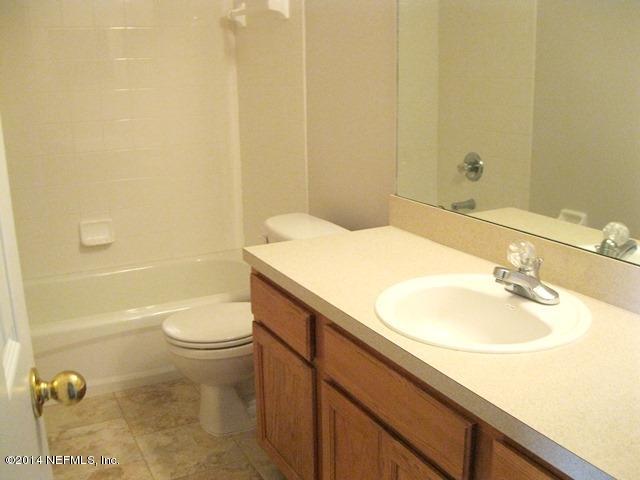 205-3 Long Bridge Road St. Johns, FL 32259 - Photo 13 of 30 a bathroom with a sink a toilet and shower