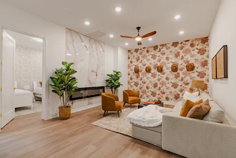 a living room with furniture and a potted plant