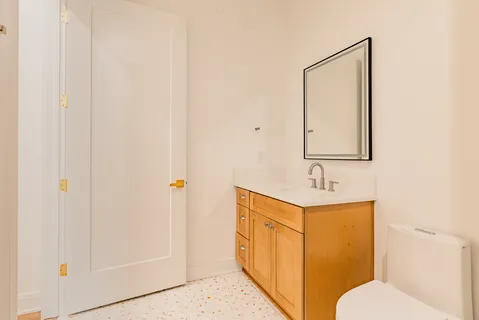 a bedroom with a bed and a chair