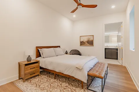 a bedroom with a bed and a couch with rug