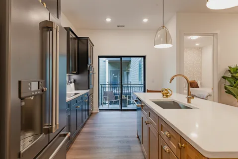 a kitchen with kitchen island a sink appliances and cabinets