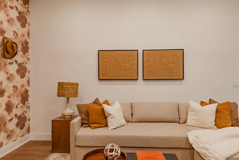 a living room with a couch and a potted plant