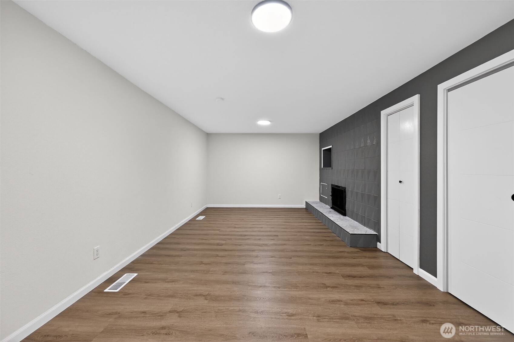 17843 110th Avenue Southeast Renton, WA 98055 - Photo 11 of 31 a view of an empty room with wooden floor and a window
