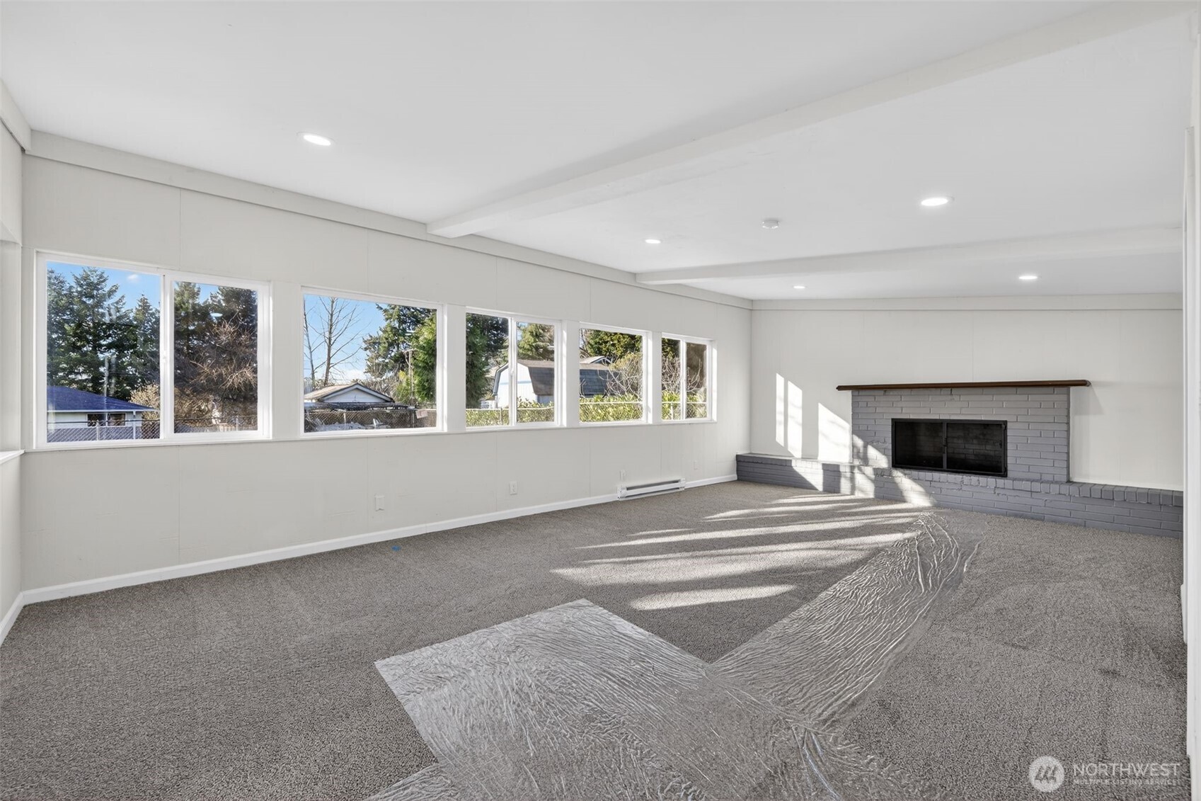 17843 110th Avenue Southeast Renton, WA 98055 - Photo 12 of 31 a view of an empty room with a fireplace and a window