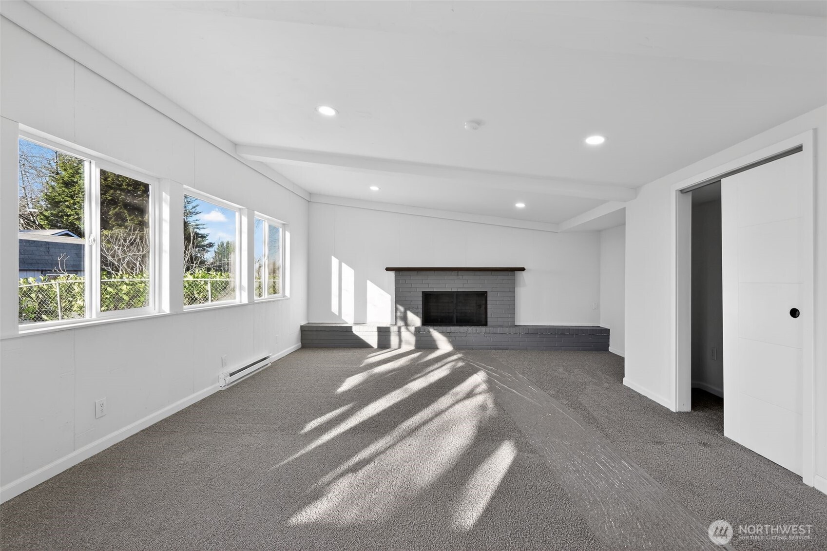 17843 110th Avenue Southeast Renton, WA 98055 - Photo 22 of 31 a view of an empty room with a fireplace and a window
