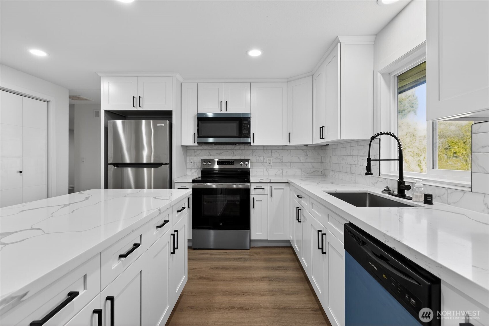 17843 110th Avenue Southeast Renton, WA 98055 - Photo 8 of 31 a kitchen with stainless steel appliances a sink stove refrigerator and cabinets