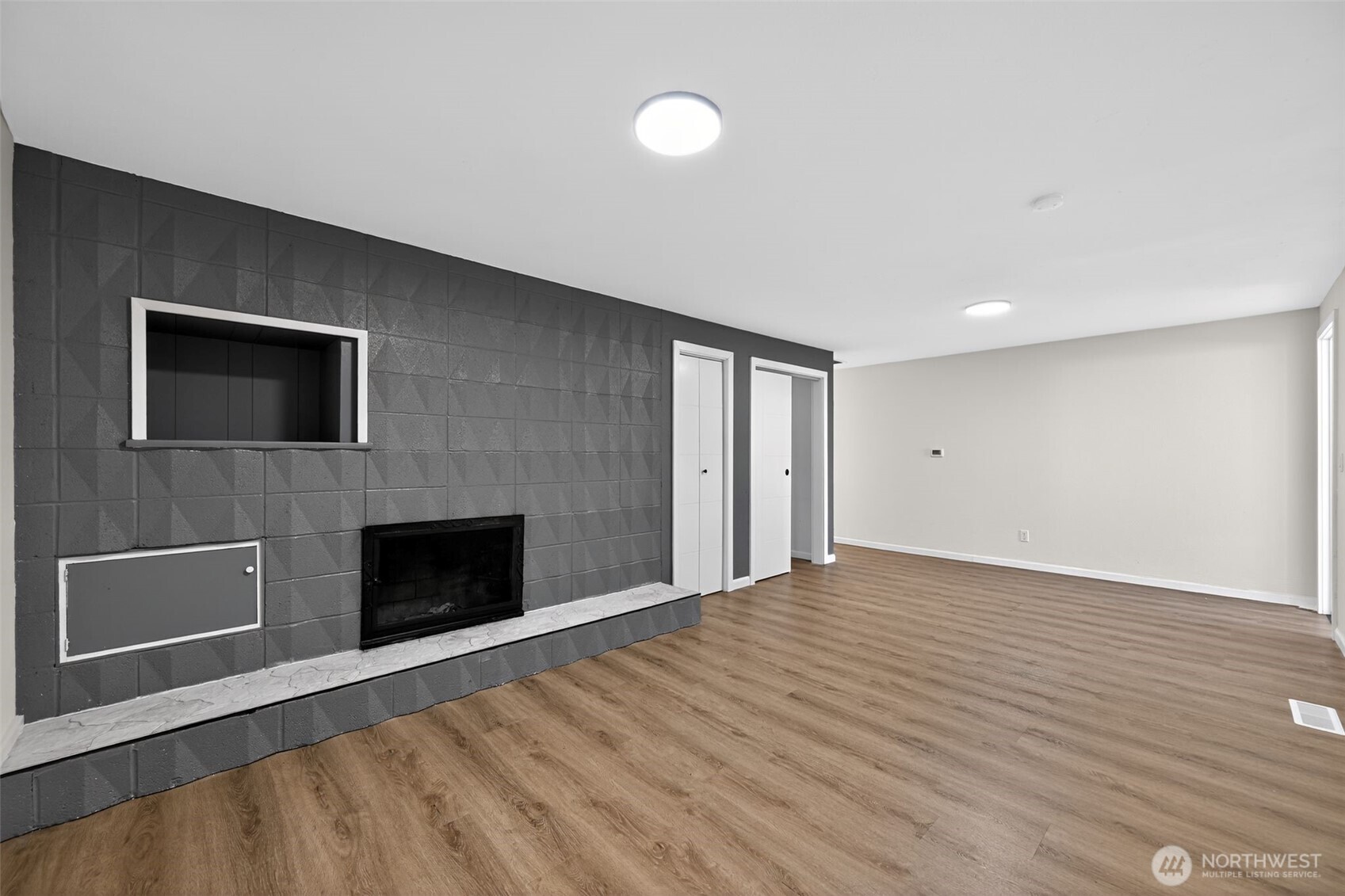 17843 110th Avenue Southeast Renton, WA 98055 - Photo 9 of 31 a view of an empty room with a fireplace and a window