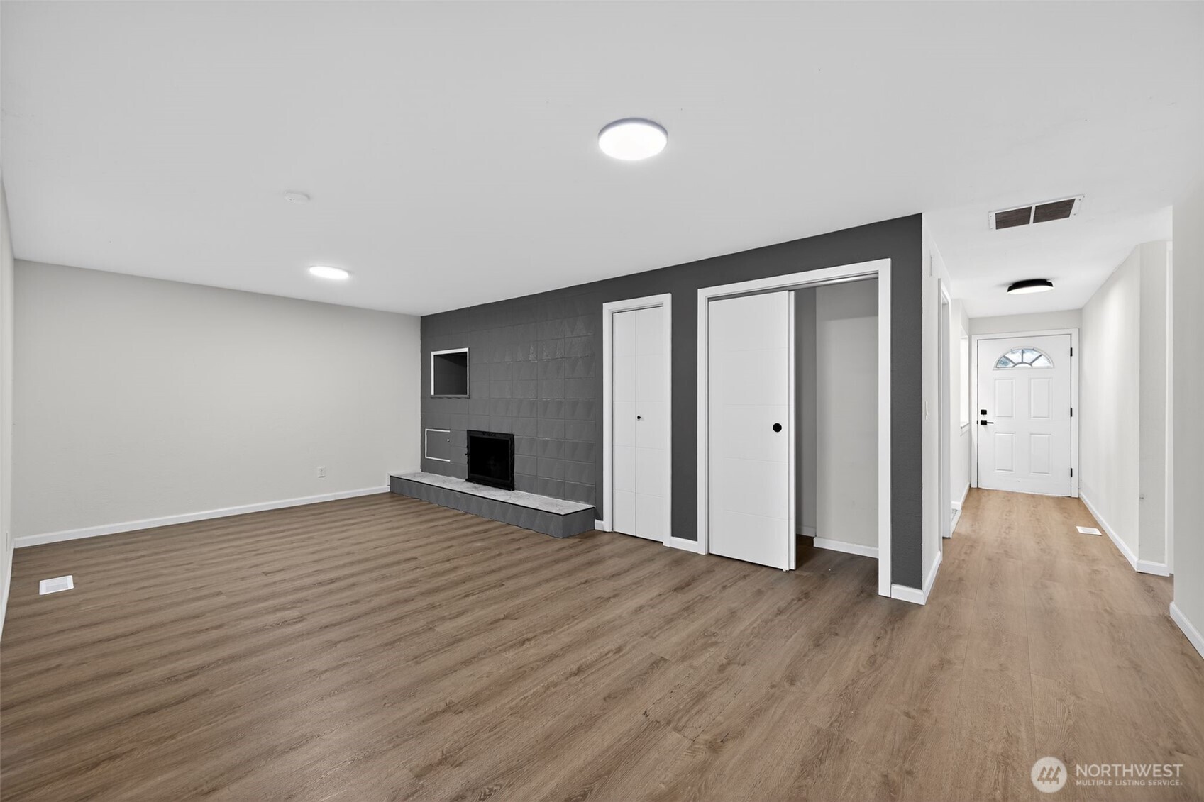 17843 110th Avenue Southeast Renton, WA 98055 - Photo 10 of 31 a view of empty room with wooden floor and fireplace