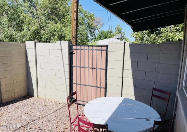 a view of a balcony with table and chairs