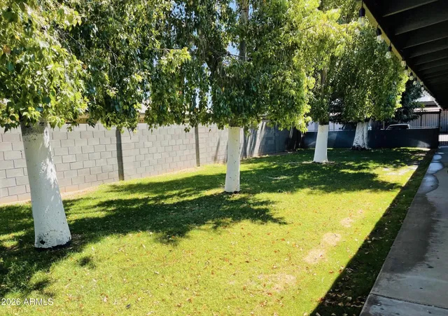 a view of a backyard with swimming pool