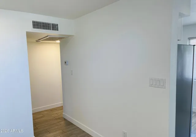 a view of empty room with wooden floor