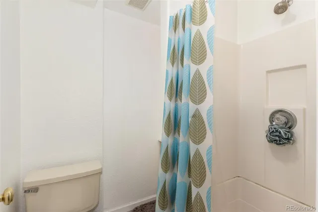 a bathroom with a shower and a toilet